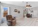 Bright living room featuring a recliner, tile flooring, ceiling fan, and a bar setup at 16417 S 43Rd Pl, Phoenix, AZ 85048