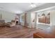 Spacious living room featuring wood floors, a recliner, and bright windows with natural light at 16417 S 43Rd Pl, Phoenix, AZ 85048