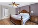 Elegant main bedroom with hardwood floors, purple accent wall, and ensuite access at 16417 S 43Rd Pl, Phoenix, AZ 85048