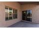 Covered patio with view of the backyard through windows and sliding glass door with access at 18297 W Spencer Dr, Surprise, AZ 85374