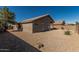 Backyard featuring desert landscaping with low-maintenance gravel, wall and covered patio area at 18297 W Spencer Dr, Surprise, AZ 85374
