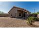 Backyard featuring a covered patio with desert landscaping and a low block wall at 18297 W Spencer Dr, Surprise, AZ 85374