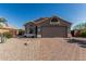Charming single-story home featuring a brick driveway and low-maintenance desert landscaping at 18297 W Spencer Dr, Surprise, AZ 85374