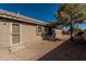 Exterior view of stucco house, showcasing backyard desert landscaping and low maintenance yard at 18297 W Spencer Dr, Surprise, AZ 85374