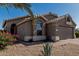 Charming single-story home featuring a brick driveway and low-maintenance desert landscaping at 18297 W Spencer Dr, Surprise, AZ 85374