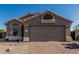 Charming single-story home featuring a brick driveway and low-maintenance desert landscaping at 18297 W Spencer Dr, Surprise, AZ 85374