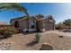 Charming single-story home featuring a brick driveway and low-maintenance desert landscaping at 18297 W Spencer Dr, Surprise, AZ 85374