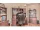 Inviting home office with built-in desk, shelving, wood floors and comfortable office chair at 18297 W Spencer Dr, Surprise, AZ 85374