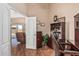 Well-appointed home office with desk, chair, and view to outdoor seating area through door at 18297 W Spencer Dr, Surprise, AZ 85374