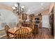 Charming eat-in kitchen with a wooden table, chandelier, and breakfast bar seating at 18297 W Spencer Dr, Surprise, AZ 85374