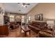 Comfortable living room with a fireplace, hardwood floors and an open floorplan at 18297 W Spencer Dr, Surprise, AZ 85374