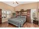 Comfortable main bedroom with vaulted ceiling, hardwood floors and plantation shutters at 18297 W Spencer Dr, Surprise, AZ 85374