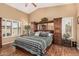Spacious main bedroom with a unique headboard, ample lighting, and wood-style flooring at 18297 W Spencer Dr, Surprise, AZ 85374