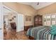 Bright main bedroom with a connected seating area and wood-style flooring at 18297 W Spencer Dr, Surprise, AZ 85374