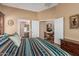 Comfortable main bedroom with a view of the dining area and ensuite bathroom at 18297 W Spencer Dr, Surprise, AZ 85374