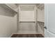 Well-organized walk-in closet with shelving, rods, and wood-style flooring at 18297 W Spencer Dr, Surprise, AZ 85374