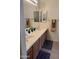Bathroom featuring double sinks and wood cabinetry at 18650 N 91St Ave # 1501, Peoria, AZ 85382