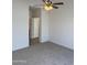 Spacious bedroom with carpet flooring and access to hallway at 18650 N 91St Ave # 1501, Peoria, AZ 85382