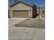 Beige home featuring a two-car garage and low maintenance desert landscaping at 18650 N 91St Ave # 1501, Peoria, AZ 85382
