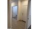 Hallway featuring wood-look floors and white trim and doors at 18650 N 91St Ave # 1501, Peoria, AZ 85382