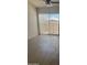 Bright living room with a ceiling fan and sliding glass door to the patio at 18650 N 91St Ave # 1501, Peoria, AZ 85382