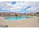 Sparkling pool with rock waterfall feature and ample deck space for lounging in a community setting at 18650 N 91St Ave # 1501, Peoria, AZ 85382