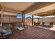 Outdoor covered patio with brick flooring, bar area and seating, perfect for entertaining at 18669 W Vista Norte St, Goodyear, AZ 85338