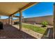 Covered patio with manicured green lawn and rock landscaping at 18669 W Vista Norte St, Goodyear, AZ 85338