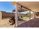 Inviting covered patio area with brick flooring, open pergola and landscape at 18669 W Vista Norte St, Goodyear, AZ 85338