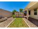 Back yard with grassy area and stone landscaping at 18669 W Vista Norte St, Goodyear, AZ 85338