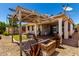Back yard with covered patio and grassy area at 18669 W Vista Norte St, Goodyear, AZ 85338