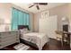 Bedroom with ceiling fan, closet, desk, and dresser at 18669 W Vista Norte St, Goodyear, AZ 85338