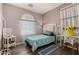 Cozy bedroom with a window seat, desk, wood floors, and colorful accents at 18669 W Vista Norte St, Goodyear, AZ 85338