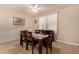 Cozy dining room features a ceiling fan, neutral paint, wainscotting, and a dark wood dining set at 18669 W Vista Norte St, Goodyear, AZ 85338