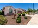 Charming single-story home features a well-maintained front yard with a two car garage and a tiled roof at 18669 W Vista Norte St, Goodyear, AZ 85338