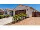 Charming single-story home features a well-maintained front yard with a two car garage and a tiled roof at 18669 W Vista Norte St, Goodyear, AZ 85338