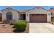Charming single-story home features a well-maintained front yard with a two car garage and a tiled roof at 18669 W Vista Norte St, Goodyear, AZ 85338
