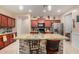 Well-lit kitchen with granite counters, wooden cabinets, stainless steel appliances, and a brick island at 18669 W Vista Norte St, Goodyear, AZ 85338