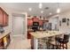 Spacious kitchen with granite counters, brick island, stainless appliances, and wood cabinets at 18669 W Vista Norte St, Goodyear, AZ 85338