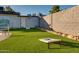 Beautiful backyard with artificial turf, a block fence, and a patio area, creating an ideal outdoor living space at 217 E Bruce Ave, Gilbert, AZ 85234