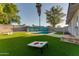 Landscaped backyard with artificial turf, a swimming pool, and a blue-painted block fence, perfect for outdoor entertainment at 217 E Bruce Ave, Gilbert, AZ 85234