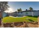 Spacious backyard featuring artificial turf, a swimming pool, and mature trees, perfect for relaxation and outdoor activities at 217 E Bruce Ave, Gilbert, AZ 85234