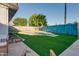 Outdoor patio with artificial turf, a swimming pool, and chairs, perfect for relaxing and enjoying the backyard scenery at 217 E Bruce Ave, Gilbert, AZ 85234