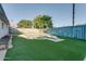 Spacious backyard featuring a swimming pool, artificial turf, and a decorative blue fence, creating a private outdoor oasis at 217 E Bruce Ave, Gilbert, AZ 85234