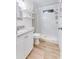 Bright bathroom featuring granite counters, white cabinets, and a tiled shower with a striped curtain at 217 E Bruce Ave, Gilbert, AZ 85234