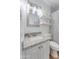Bright bathroom featuring granite counters, white cabinets, and a tiled shower with a striped curtain at 217 E Bruce Ave, Gilbert, AZ 85234