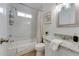 Bright bathroom featuring granite counters, white cabinets, and a tiled shower and tub combination at 217 E Bruce Ave, Gilbert, AZ 85234