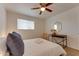 Cozy bedroom featuring a ceiling fan, comfortable bed, and a stylish console table with mirror at 217 E Bruce Ave, Gilbert, AZ 85234