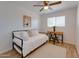 Bright bedroom with hardwood floor featuring a bed and desk area with natural light at 217 E Bruce Ave, Gilbert, AZ 85234