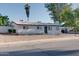 A view of the front of the house with low maintenance landscaping, sidewalk, and driveway at 217 E Bruce Ave, Gilbert, AZ 85234